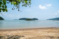 Small tropical island with trees and rocks in the middle of sea and cloudy blue sky background. Landscape beach view in Endau, Mal Royalty Free Stock Photo