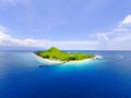 Small tropical island with white green savannah and sandy beach. Beautiful Kenawa island view from above. Nature of the Indonesia