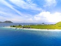 Small tropical island with white green savannah and sandy beach. Beautiful Kenawa island view from above. Nature of the Indonesia