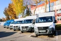 Small trucks, vans, courier minibuses stand in a row ready for d