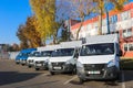 Small trucks, vans, courier minibuses stand in a row ready for delivery of goods on the terms of DAP, DDP