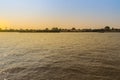 Small tugboat is pulling a large shipping barge up the Chao Phraya River in Bangkok, Thailand. Royalty Free Stock Photo