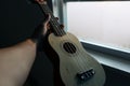 Small ukelele at window Royalty Free Stock Photo
