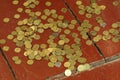 Small Ukrainian coins are scattered on the wooden floor.