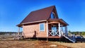 A small unfinished country house in the middle of a field. Building a new cottage in nature in the spring with good Royalty Free Stock Photo