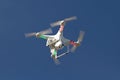 Small unmanned helicopter with a camera floating in the sky Royalty Free Stock Photo