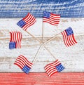 Small USA flags in pinwheel formation on rustic boards with national colors Royalty Free Stock Photo