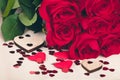 Small Valentine red hearts and fresh roses