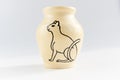 Small vase with an Egyptian cat made of beige clay covered with transparent glaze. Ancient Egyptian hieroglyph