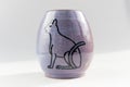Small vase with an Egyptian cat made of red clay covered with transparent glaze. Ancient Egyptian hieroglyph. the glaze