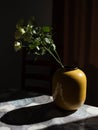 a small vase with a plant on a table