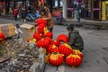 Small vendor who is assembling red lanterns