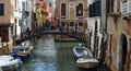 Small Venice Canal with Boats Bridge and People. Royalty Free Stock Photo