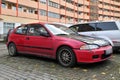 Old classic veteran dented red coupe car Honda Civic parked Royalty Free Stock Photo