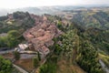 Small village of Chiusure on top of the hill surrounded by Karst cliffs landscape photographed with a drone. Royalty Free Stock Photo