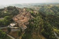 Small village of Chiusure on top of the hill surrounded by Karst cliffs landscape photographed with a drone. Royalty Free Stock Photo