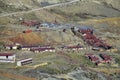 Small village houses with red roofs near mountain road Royalty Free Stock Photo