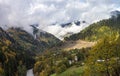 The  small village and mountain slopes covered with forests and low thunderclouds in Svaneti in the mountainous part of Georgia Royalty Free Stock Photo