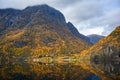 Small village on the waterfront and mountains in the autumn season that reflect the water in Norway Royalty Free Stock Photo