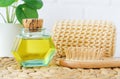 Small vintage bottle with cosmetic (massage, cleansing) aroma oil and wooden hairbrush. Natural hair care, homemade spa Royalty Free Stock Photo