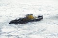 Saint Petersburg, Russia - 28.18.2022 small vintage icebreaker ship make their way through the frozen icy sea