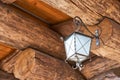 Small vintage lantern hanging on a wooden wall Royalty Free Stock Photo