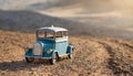 Small vintage style tin car on a dirt road. Old toy car. Collectible vehicle Royalty Free Stock Photo