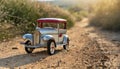 Small vintage style tin car on a dirt road. Old toy car. Collectible vehicle Royalty Free Stock Photo