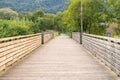 Small walkway pedestrian wooden bridge through the river in park Royalty Free Stock Photo