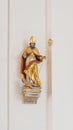 A small, wall-mounted sculpture of Saint Augustine in the Jesuitenkirche church in Heidelberg, Germany