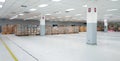 Small warehouse logistic or distribution center in electronic industry. Interior of warehouse with rows of shelves with big boxes