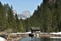 Small water dam surrounded by snow with wooden house near by tourist path heading directly towards to Murg lakes Royalty Free Stock Photo