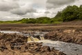 A small waterfall and bedrock exposed due to Earlstoun Dam due to drained Royalty Free Stock Photo