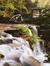Small waterfall with bicycle Royalty Free Stock Photo
