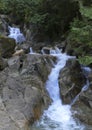 Small Waterfall Cascade in Rocky Stream as it rushes through the Forest Royalty Free Stock Photo