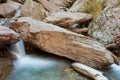 Small waterfall casdcading over rocks in blue pond Royalty Free Stock Photo