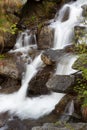 Small waterfall of a creek downhill to the Gran Paradiso National Park Royalty Free Stock Photo