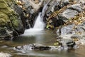 Small waterfall between dark rocks Royalty Free Stock Photo