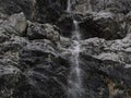 small waterfall on detail of rock of monte croce cross mountain in dolomites badia valley panorama landscape Royalty Free Stock Photo