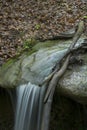 Small waterfall dropping onto rocks Royalty Free Stock Photo