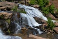 Small waterfall flowing down a rockface in the forest Royalty Free Stock Photo