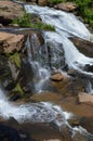 Small waterfall flowing down a rockface in the forest Royalty Free Stock Photo