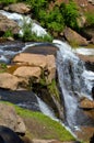 Small waterfall flowing down a rockface in the forest Royalty Free Stock Photo