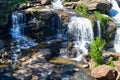 Small waterfall flowing down a rockface in the forest Royalty Free Stock Photo