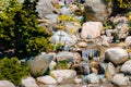 Small waterfall flowing into a pond at the Japanese gardens in Grand Rapids Michigan Royalty Free Stock Photo