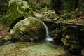 A small waterfall that flows over the boulders of a stream (Italy, Europe) Royalty Free Stock Photo