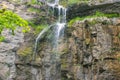 small waterfall that flows from road parapet. Royalty Free Stock Photo