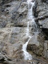 Small waterfall on the gray and brown rocks