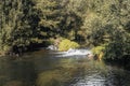 Small waterfall in green pond in Terras de Bouro, Portugal Royalty Free Stock Photo