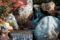 Small waterfall in the japanese garden at the Frederik Meijer Gardens in Grand Rapids Michigan during the fall Royalty Free Stock Photo